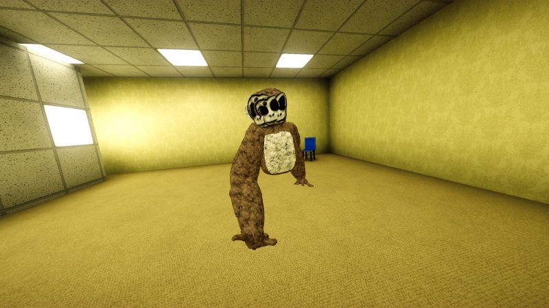 Still Ape, a brown ape with a cream chest and a pale mask-like face, in a yellow carpeted room